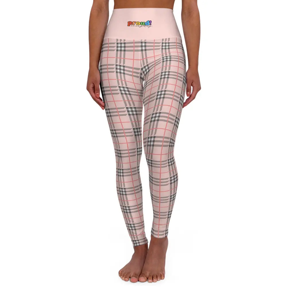 A person wearing a pair of high waisted yoga leggings with a plaid pattern and a visible brand logo that reads "proud everyday" on the waistband.