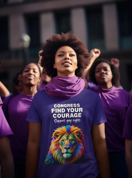 A person wearing a purple t-shirt with a graphic and text that supports gay rights, standing in front of a group of people engaged in a demonstration.