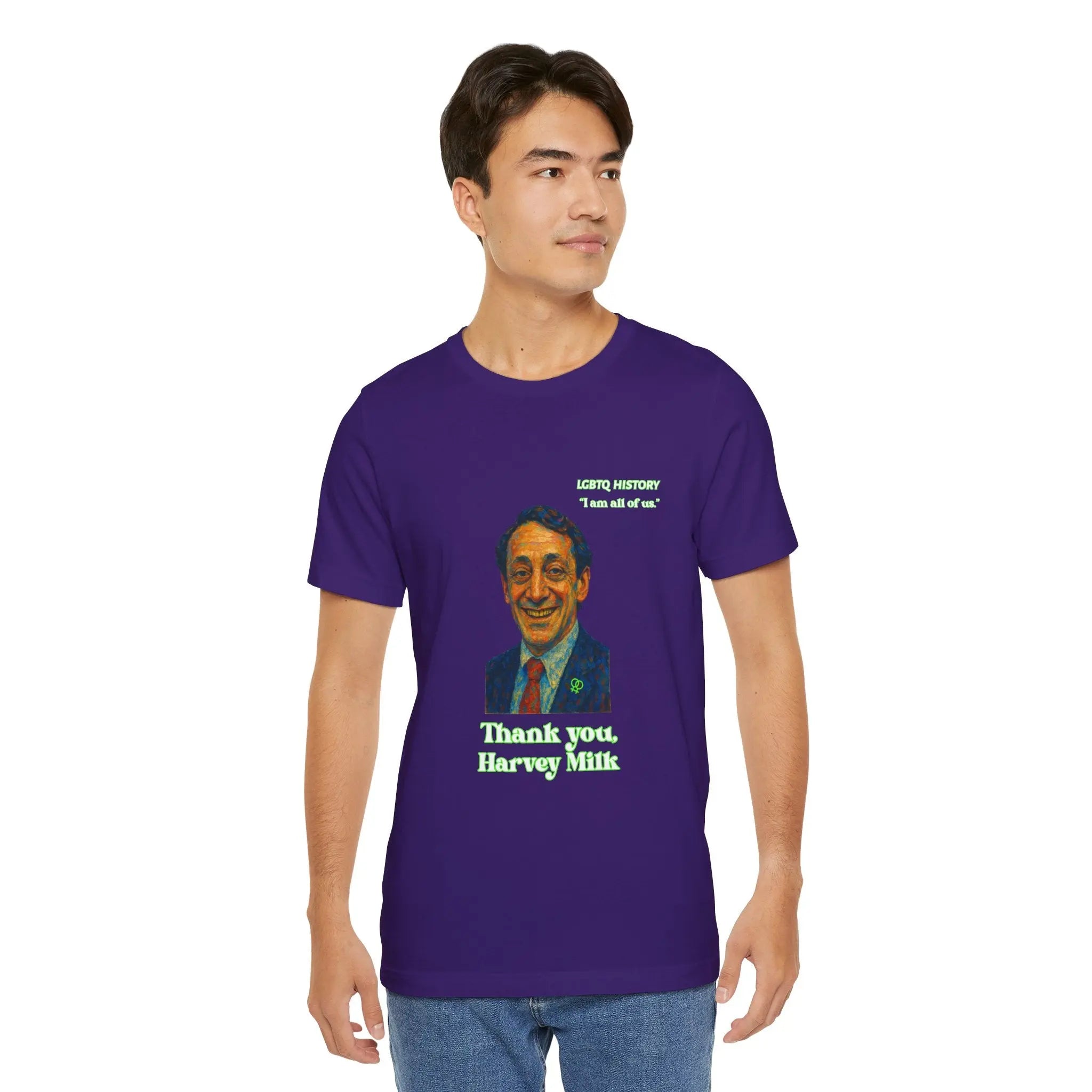 Man wearing a purple t-shirt with a Harvey Milk graphic and text, standing against a white background