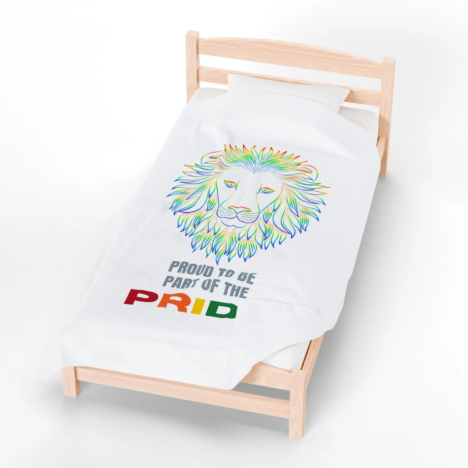 White blanket with rainbow lion design and 'Proud to be part of the Pride' text on a bed.