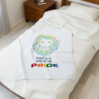 White throw blanket with rainbow lion design and 'Proud to be part of the Pride' text on a bed.
