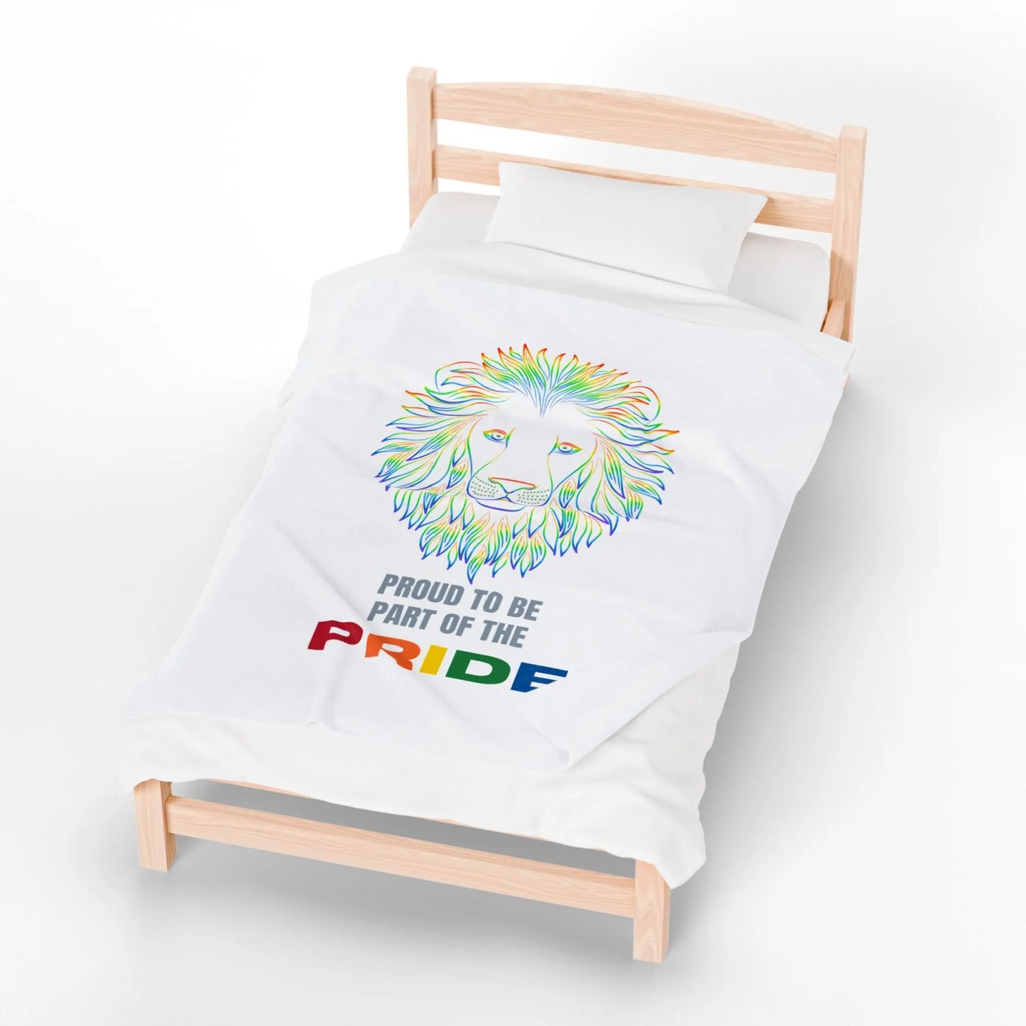 White throw blanket with rainbow lion design and 'Proud to be part of the Pride' text on a bed.