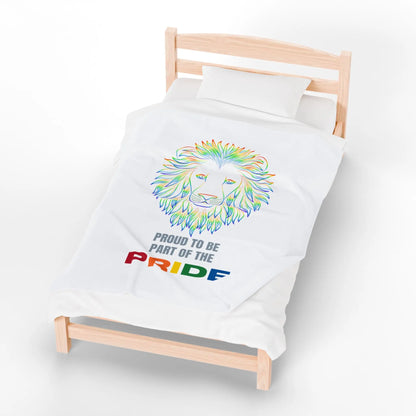 White throw blanket with rainbow lion design and 'Proud to be part of the Pride' text on a bed.