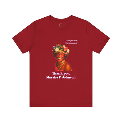 Red t-shirt with a graphic of Marsha P. Johnson wearing a flower crown and text on a white background