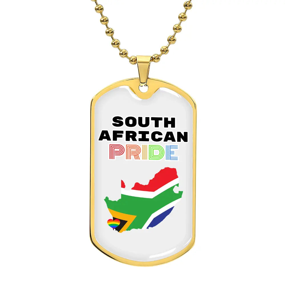 A gold dog tag necklace with 'SOUTH AFRICAN PRIDE' written on it and the colors of the South African flag in the background.