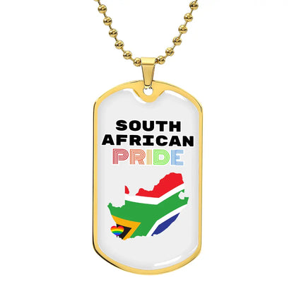 A gold dog tag necklace with 'SOUTH AFRICAN PRIDE' written on it and the colors of the South African flag in the background.