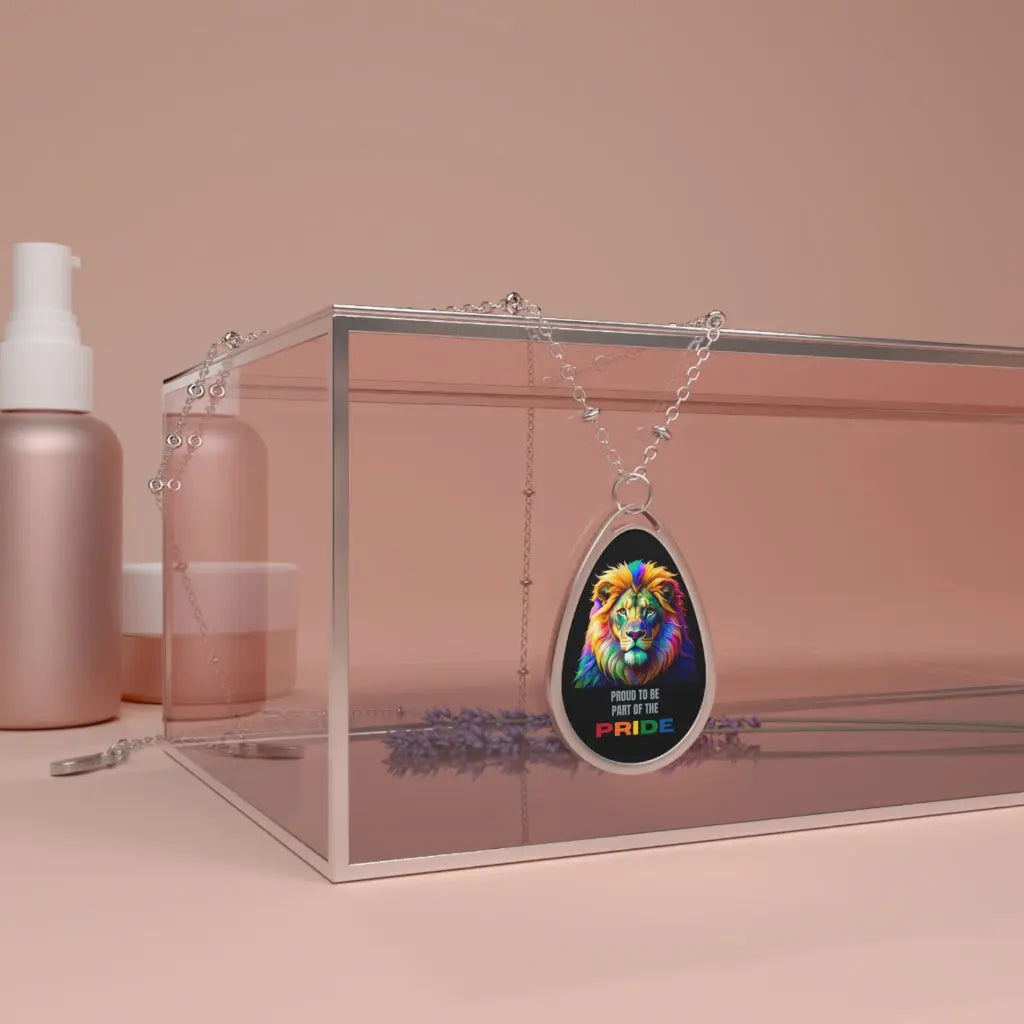 Necklace with a colorful lion pendant and 'Proud to be Pride' text in a clear box on a pink background.