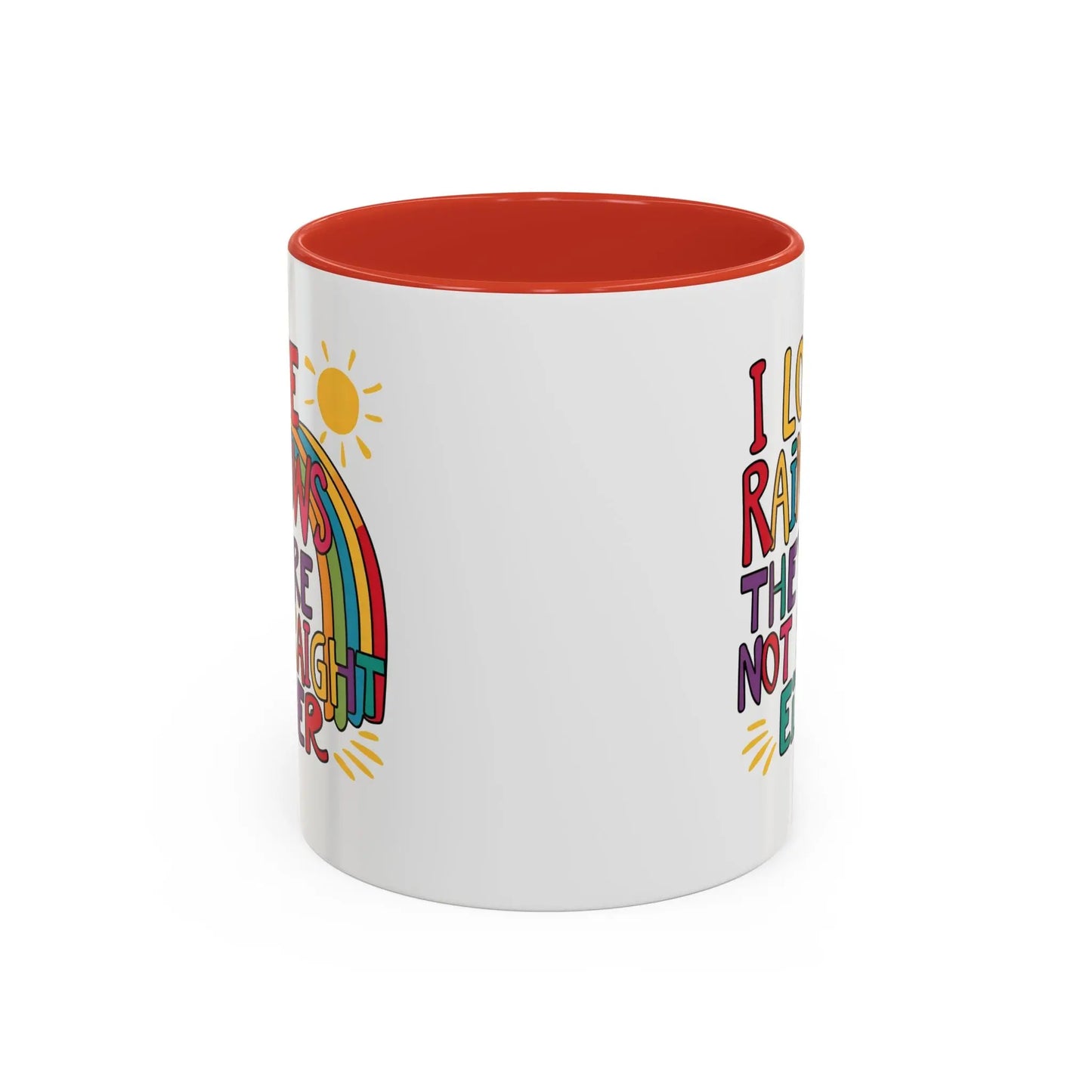 A white ceramic coffee mug with a red handle and interior, featuring the colorful text 'I LOVE RAINBOWS THEY'RE NOT STRAIGHT EITHER' along with a graphic of a rainbow and a sun.
